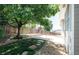 A lush backyard with mature trees, gravel, and green grass at 18656 E Harvard Dr, Aurora, CO 80013
