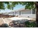Backyard patio with stone and concrete features patio furniture, landscaping and privacy fence at 18656 E Harvard Dr, Aurora, CO 80013
