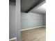 Spacious finished basement boasts gray walls and wood-look flooring, offering a modern aesthetic at 18656 E Harvard Dr, Aurora, CO 80013