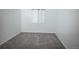 A comfortable bedroom featuring soft gray carpeting and a bright window at 18656 E Harvard Dr, Aurora, CO 80013