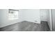 Bright empty bedroom features wood floors and a large window for natural light at 18656 E Harvard Dr, Aurora, CO 80013
