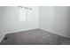 Bright bedroom with plush carpeting and a window offering natural light at 18656 E Harvard Dr, Aurora, CO 80013