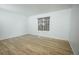 Bright bedroom features wood-look flooring and a large window offering natural light at 18656 E Harvard Dr, Aurora, CO 80013