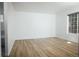 Bright bedroom featuring wood-look floors and a window for natural light at 18656 E Harvard Dr, Aurora, CO 80013
