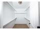 A bright, walk-in closet with hardwood floors and custom shelving at 18656 E Harvard Dr, Aurora, CO 80013