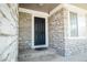 Stone exterior with a stylish black front door at 18656 E Harvard Dr, Aurora, CO 80013