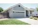A cozy home with a two-car garage and well-maintained front lawn in a suburban setting at 18656 E Harvard Dr, Aurora, CO 80013