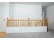 Upstairs hallway featuring modern wooden handrail and a neutral carpet at 18656 E Harvard Dr, Aurora, CO 80013