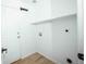 A utility room with a white door, shelf, and washer hookups at 18656 E Harvard Dr, Aurora, CO 80013