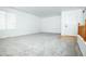 Empty living room featuring neutral carpet and white walls with a window at 18656 E Harvard Dr, Aurora, CO 80013