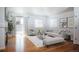 Bright living room with hardwood floors, a fireplace, neutral walls, and modern furniture at 18656 E Harvard Dr, Aurora, CO 80013