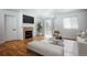 Bright living room with hardwood floors, fireplace, and neutral walls, staged with modern furniture at 18656 E Harvard Dr, Aurora, CO 80013