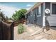 Home's side yard with gravel, stepping stones, and a wooden fence at 18656 E Harvard Dr, Aurora, CO 80013