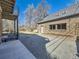 Private backyard with a patio, gravel area, and a well-maintained brick exterior at 2540 Forest St, Denver, CO 80207