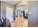 Elegant foyer with hardwood floors, neutral wall color, and arched doorway leading to the living spaces at 2540 Forest St, Denver, CO 80207