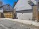 Attached garage with a gray door, complemented by brick and siding exterior finishes at 2540 Forest St, Denver, CO 80207