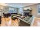 Bright living room featuring a fireplace, hardwood floors, comfortable seating, and a view to the dining area at 2540 Forest St, Denver, CO 80207