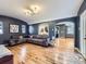 Stylish living room with hardwood floors, textured walls, and an open archway to the neighboring rooms at 2540 Forest St, Denver, CO 80207