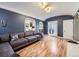 Comfortable living room with hardwood floors, a gray sofa, and a view to the backyard through sliding glass doors at 2540 Forest St, Denver, CO 80207