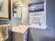 Cozy powder room with a modern vanity, faucet, and a window that brings in natural light at 2540 Forest St, Denver, CO 80207