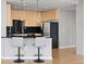 Modern kitchen with breakfast bar and stainless steel appliances at 1700 Bassett St # 1105, Denver, CO 80202