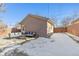 Large backyard with patio, detached garage, and snowy ground at 1460 S Emerson St, Denver, CO 80210