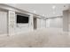 Large, open basement recreation area with built-in shelving and TV at 1460 S Emerson St, Denver, CO 80210