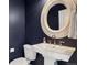 Powder room with pedestal sink and ornate mirror at 1460 S Emerson St, Denver, CO 80210