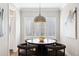 Bright dining room with window shutters, round table, and four chairs at 1460 S Emerson St, Denver, CO 80210