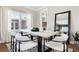 Elegant dining room with a large table, white chairs, and natural light at 1460 S Emerson St, Denver, CO 80210