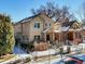 Two-story house with stone accents and a fenced yard at 1460 S Emerson St, Denver, CO 80210