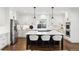 Modern kitchen with white cabinets, large island, and stainless steel appliances at 1460 S Emerson St, Denver, CO 80210