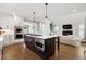 Open concept kitchen with island, stainless steel appliances, and view into living room at 1460 S Emerson St, Denver, CO 80210