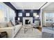 Living room with a navy-blue accent wall, fireplace, and comfortable seating at 1460 S Emerson St, Denver, CO 80210