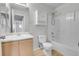 Well-lit bathroom featuring a shower-tub combo and modern vanity at 7977 S Kittredge St, Englewood, CO 80112