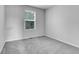Neutral bedroom features carpet, light walls, and a window at 7977 S Kittredge St, Englewood, CO 80112