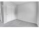 A carpeted bedroom featuring a closet with sliding doors at 7977 S Kittredge St, Englewood, CO 80112