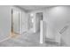 Upstairs hall featuring neutral walls and carpets, along with multiple doors at 7977 S Kittredge St, Englewood, CO 80112