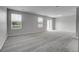Spacious living room with plush carpeting, bright windows and a sliding glass door at 7977 S Kittredge St, Englewood, CO 80112