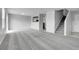 Open-concept living room featuring neutral carpeting, a staircase, and kitchen access at 7977 S Kittredge St, Englewood, CO 80112