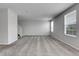 Open-concept living room with lots of space featuring carpet, lots of light, and staircase at 7977 S Kittredge St, Englewood, CO 80112