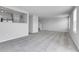 Bright and airy living room features plush carpeting, open floor plan, and staircase access at 7977 S Kittredge St, Englewood, CO 80112