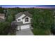 Aerial view of a well-maintained home, with a two-car garage, complemented by mature trees at 7158 Torrey St, Arvada, CO 80007