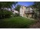 Spacious backyard featuring lush lawn and a charming deck perfect for outdoor relaxation and entertaining at 7158 Torrey St, Arvada, CO 80007