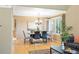 Elegant dining area with a modern chandelier, plantation shutters, and hardwood floors at 7158 Torrey St, Arvada, CO 80007