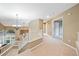 Bright foyer with grand staircase and chandelier at 7158 Torrey St, Arvada, CO 80007