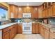 Spacious kitchen featuring granite countertops, stainless steel appliances, and custom cabinetry at 7158 Torrey St, Arvada, CO 80007