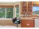 Cozy kitchen nook with granite countertops, bar seating, and natural light from the window at 7158 Torrey St, Arvada, CO 80007