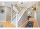 Spacious foyer with a staircase leading to the upper level, showcasing natural light and hardwood floors at 7158 Torrey St, Arvada, CO 80007