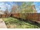 A serene backyard with green grass and a wood fence at 6424 S Routt St, Littleton, CO 80127